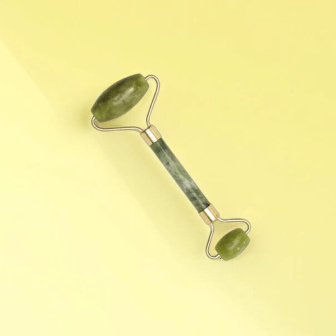 Natural jade roller with two different sized rollers used for skin care and face lifting.