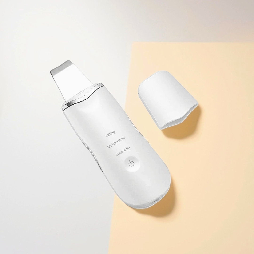 3 in 1 ultrasonic skin scrubber and pore cleansing device with a single button on the front and a small, detachable pad.
