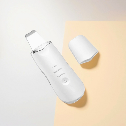 3 in 1 ultrasonic skin scrubber and pore cleansing device with a single button on the front and a small, detachable pad.