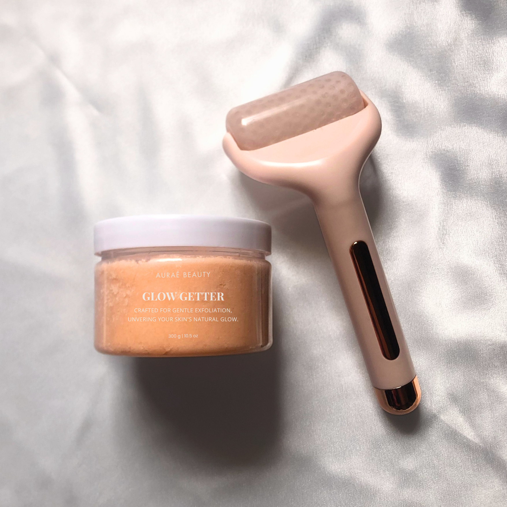 The glow boost duo includes organic sugar glow getter body scrub by Auraé Beauty and ice roller massager for a lifted face and glowing, soft and smooth skin