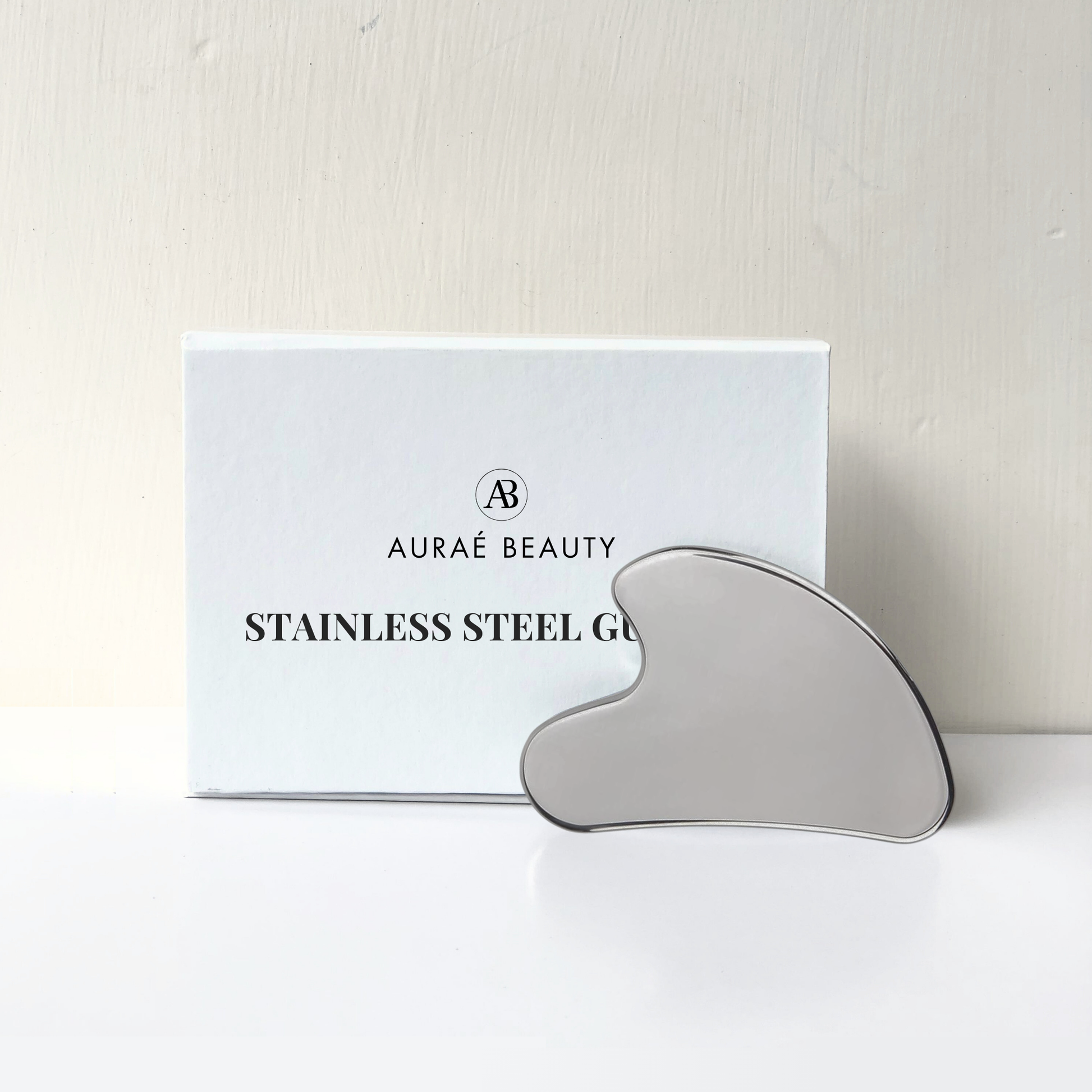 Stainless steel gua sha tool by Auraé Beauty for face lifting.