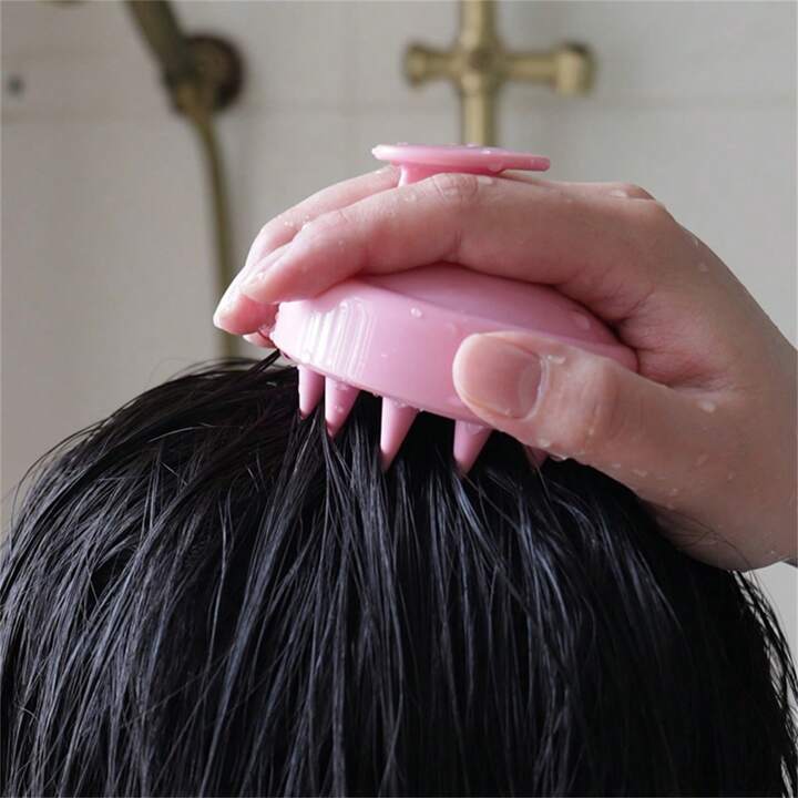 Close of scalp massager using it on the scalp